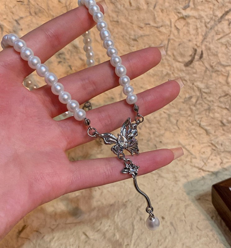Pearl necklace with a silver butterfly pendant